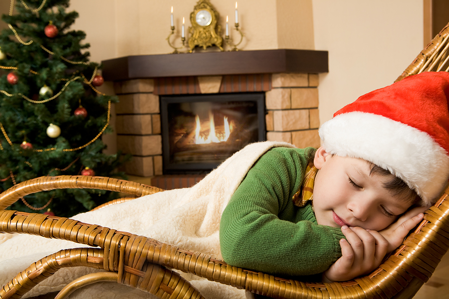 Child sleeping in front of fireplace